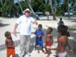 John plays soccer with some of the children