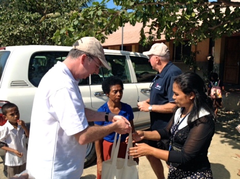 Mark Fraser handing over a sample of the art and craft supplies donated by MAMA to the Alola Foundation.